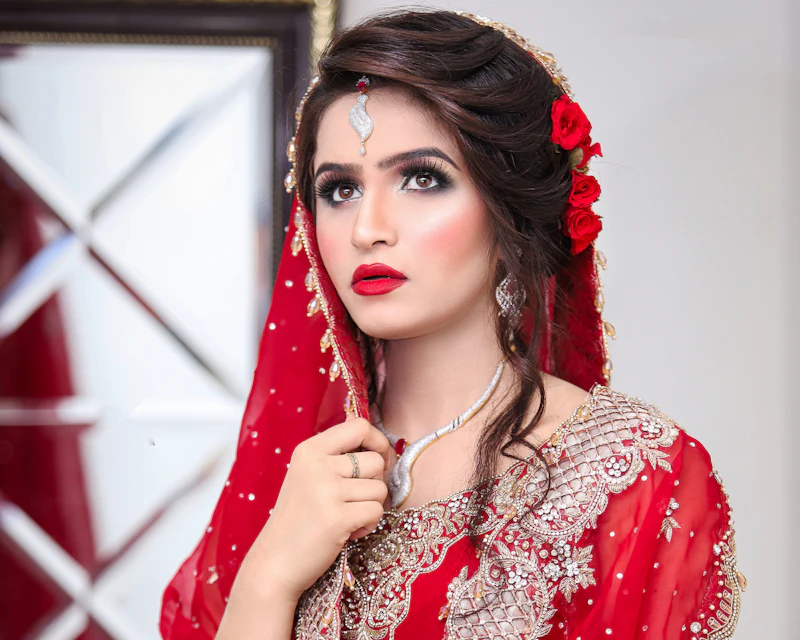 Bride in red with a dupatta over her head