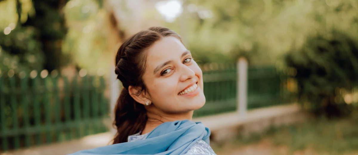Woman in a blue shalwar kameez with a flowing dupatta