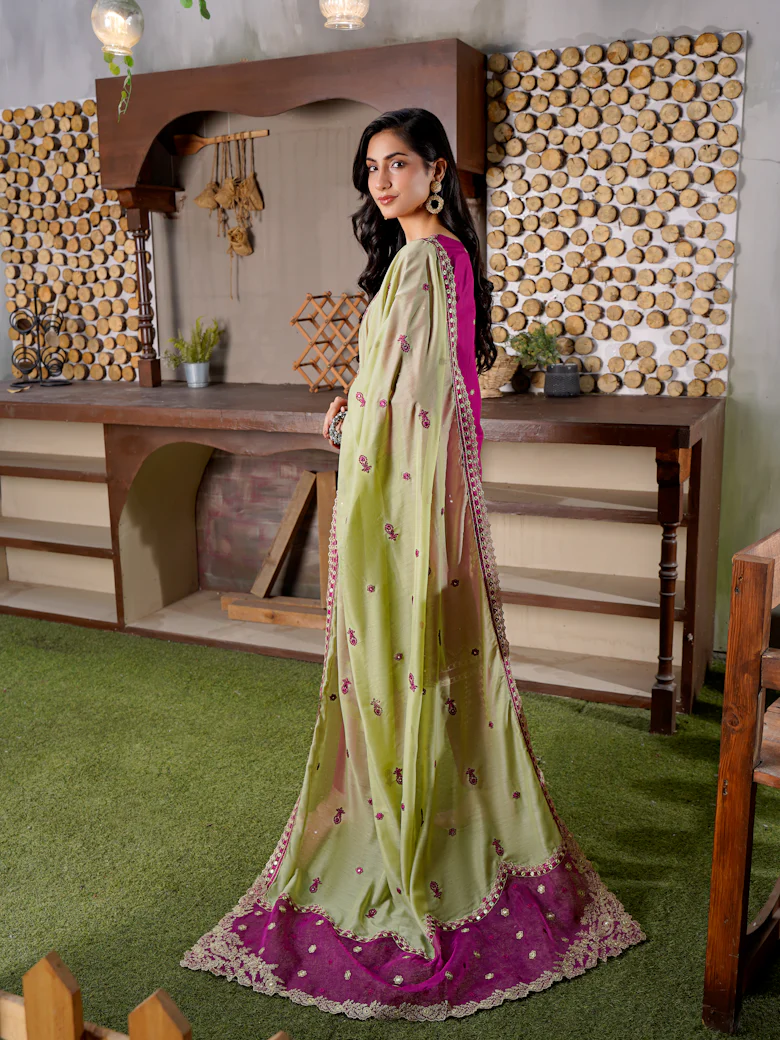 Woman in an elegant embroidered outfit with a long dupatta