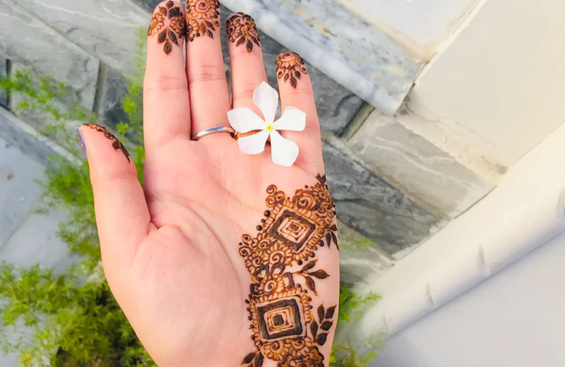 Hand with an intricate mehndi design